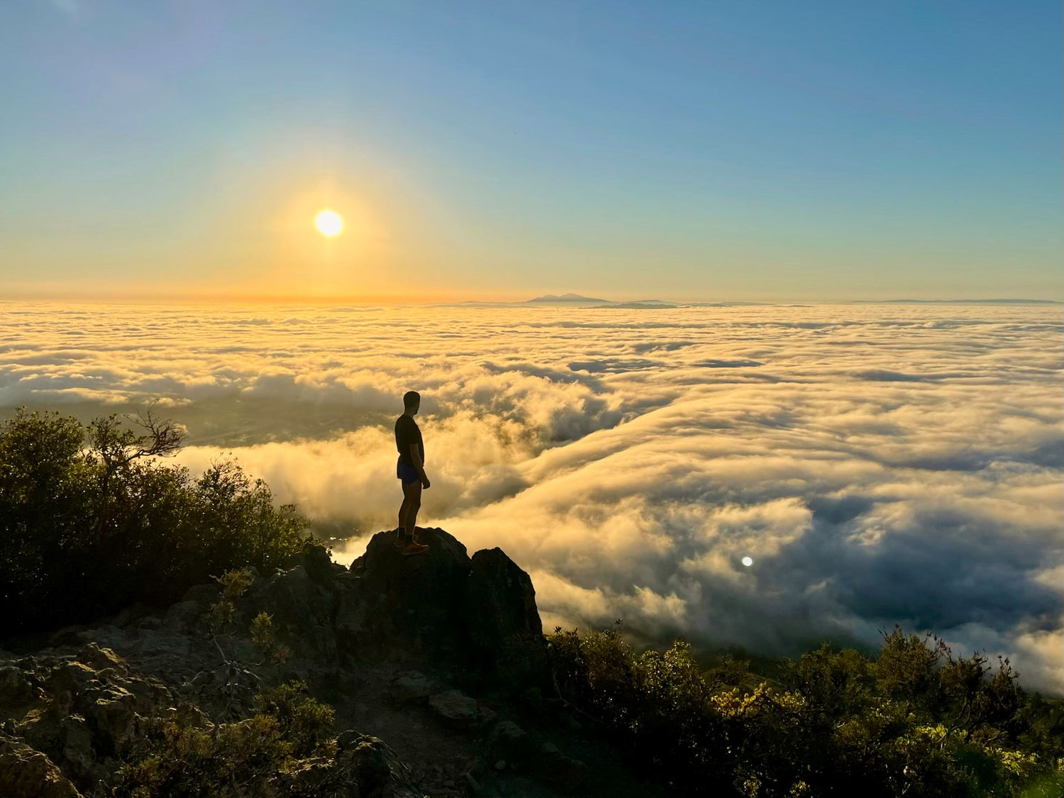Person on a mountain above the clouds